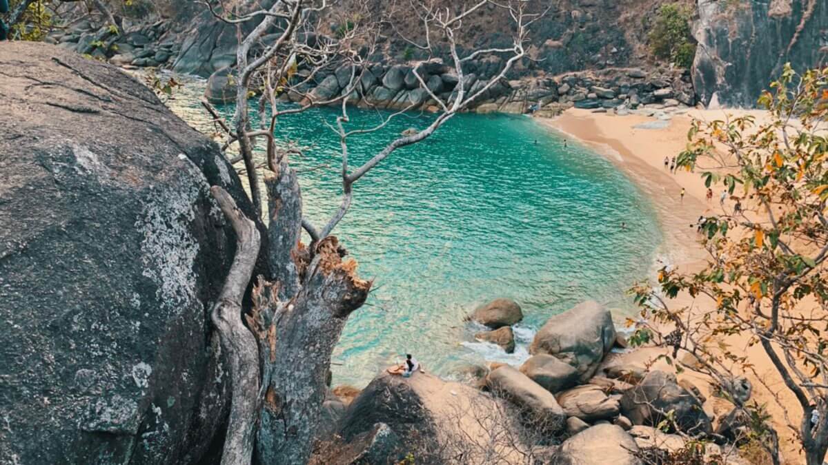 Still turquoise pool inside the rocky cove